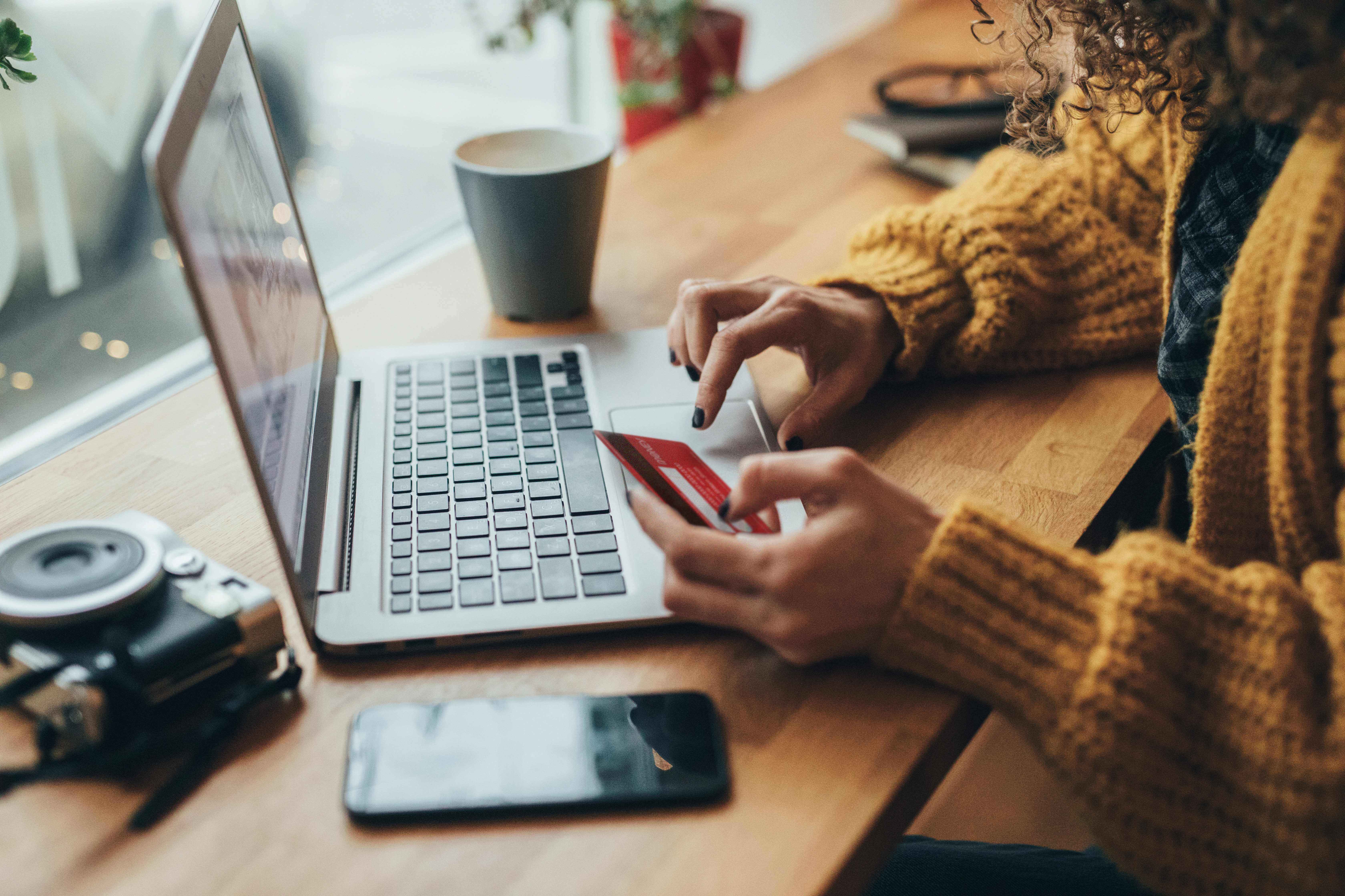Woman using her card with a laptop
