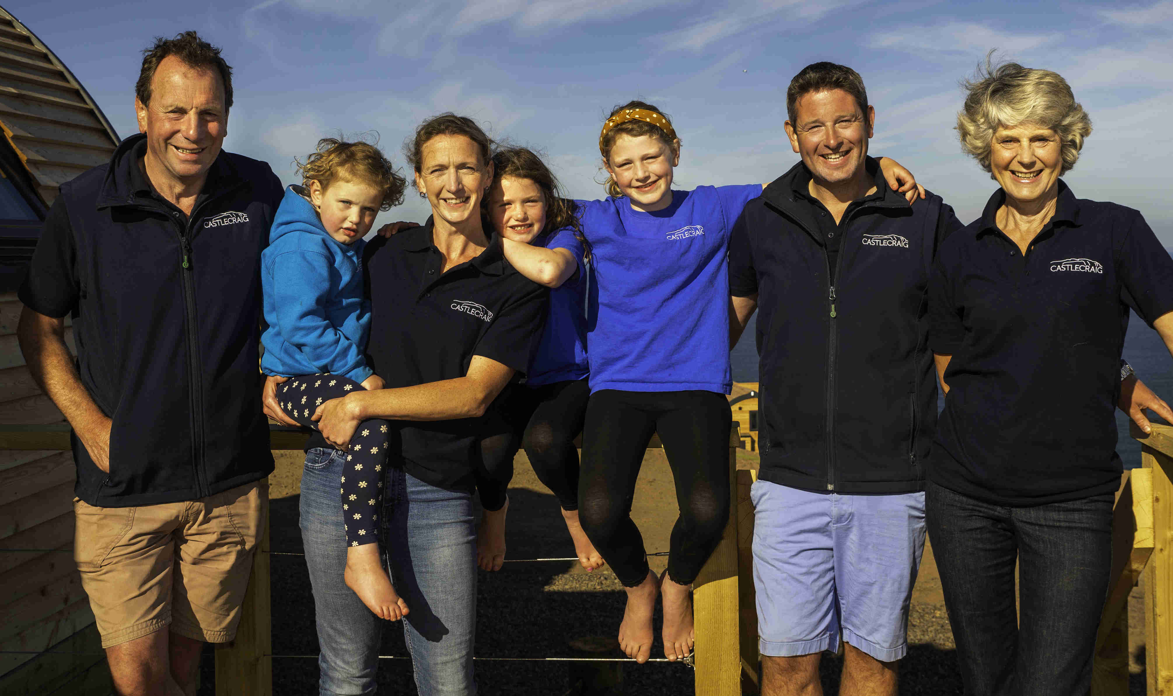 Brian Richardson standing in a field of sheep